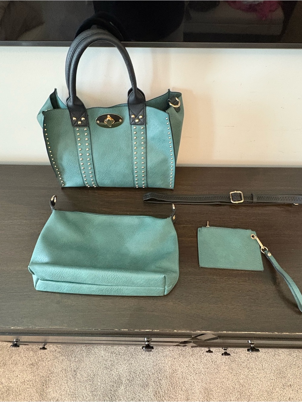 3 bags in 1.  Green tote with gold toned hardware with wristlet.